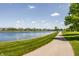 Scenic view of a tranquil lake lined with beautiful homes and a walking path at 1799 Hourglass Dr, Carmel, IN 46032