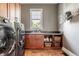Bright laundry room features a dark washer and dryer set, window, sink, counter, and ample cabinet and shelf storage at 1799 Hourglass Dr, Carmel, IN 46032