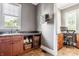 This bright laundry room features a sink, counter, cabinet, shelf storage, drying rack, and an adjacent office space at 1799 Hourglass Dr, Carmel, IN 46032