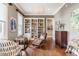 Comfortable living room with hardwood floors, a decorative chandelier, and a large bookcase at 1799 Hourglass Dr, Carmel, IN 46032