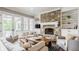 Bright living room featuring a stone fireplace, comfortable seating, and access to an outdoor space at 1799 Hourglass Dr, Carmel, IN 46032