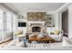 Comfortable living room with a stone fireplace, built-in shelves, and seating around a wooden coffee table at 1799 Hourglass Dr, Carmel, IN 46032