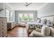 Comfortable bedroom with a ceiling fan, many windows for bright light, and a seating area with an upholstered chaise lounge at 1799 Hourglass Dr, Carmel, IN 46032