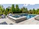 Outdoor pool area featuring a spa and lounge chairs perfect for relaxation and entertaining at 1799 Hourglass Dr, Carmel, IN 46032