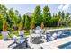 Inviting poolside lounge area with Adirondack chairs and a cozy fire pit at 1799 Hourglass Dr, Carmel, IN 46032