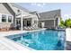 Sparkling swimming pool featuring tanning deck, waterfalls and outdoor lounging at 1799 Hourglass Dr, Carmel, IN 46032