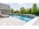 Beautiful swimming pool with lounge chairs, hot tub, and lush landscaping at 1799 Hourglass Dr, Carmel, IN 46032
