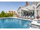 Backyard swimming pool and patio with lounge seating, pergola and grill area at 1799 Hourglass Dr, Carmel, IN 46032