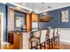 Stylish wet bar with brick accents, seating, and modern appliances, perfect for entertaining at 1799 Hourglass Dr, Carmel, IN 46032