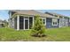 A cozy, low-maintenance backyard is accented by a young, decorative tree at 1807 Orchard Dr, Fortville, IN 46040