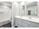 Modern bathroom with double sink vanity, large mirrors, and a clean, well-lit shower/tub combination at 1807 Orchard Dr, Fortville, IN 46040