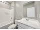 Clean bathroom with a sleek vanity, a white tub/shower combo, and modern fixtures at 1807 Orchard Dr, Fortville, IN 46040
