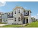 Charming two-story home featuring a two-car garage, well-manicured lawn, and stylish blue and gray siding at 1807 Orchard Dr, Fortville, IN 46040