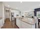 Bright, open kitchen with stainless steel appliances, a central island with granite countertops, and hardwood floors at 1807 Orchard Dr, Fortville, IN 46040