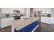 Spacious kitchen island featuring granite countertops, a stainless steel sink, and elegant white cabinets at 1807 Orchard Dr, Fortville, IN 46040