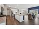 Open-concept kitchen flowing into the living area, featuring stainless steel appliances and a large island at 1807 Orchard Dr, Fortville, IN 46040