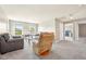 Spacious living room featuring plush seating, ample natural light, and a separate office at 1807 Orchard Dr, Fortville, IN 46040
