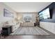 Bright living room offers a cozy sitting area, entertainment unit, and ample natural light at 1807 Orchard Dr, Fortville, IN 46040