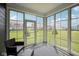 Sunroom with large windows showcasing the backyard at 1807 Orchard Dr, Fortville, IN 46040