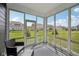 Inviting sunroom with large windows and a backyard view at 1807 Orchard Dr, Fortville, IN 46040