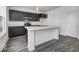 Modern kitchen with dark wood cabinets, marble countertops, and stainless steel appliances at 1943 Black Oak Dr, Shelbyville, IN 46176