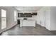Modern kitchen with dark cabinetry, a center island with seating, and stainless steel appliances at 1943 Black Oak Dr, Shelbyville, IN 46176