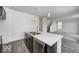 Modern kitchen view featuring an island with marble countertops, stainless steel appliances, and wood-look flooring at 1943 Black Oak Dr, Shelbyville, IN 46176