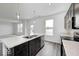Bright kitchen boasts marble countertops, stainless steel appliances, and wood-look flooring at 1943 Black Oak Dr, Shelbyville, IN 46176
