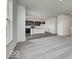 Open concept living room showcasing kitchen with dark cabinets, center island, carpet, and hard surface flooring at 1943 Black Oak Dr, Shelbyville, IN 46176
