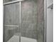Shower with sliding glass door and tiled walls at 1943 Black Oak Dr, Shelbyville, IN 46176