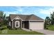 Charming home featuring a neutral color scheme, attached two-car garage, and well manicured lawn at 2008 Black Oak Dr, Shelbyville, IN 46176