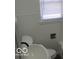 Bright bathroom with white tiled walls and a window at 201 W Essex St, Lebanon, IN 46052
