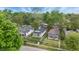 An aerial view showcases the property nestled among lush trees in a quiet neighborhood, with well-maintained lawns at 2030 Houston St, Indianapolis, IN 46218
