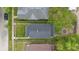 An aerial view displays the home's roof and surrounding green yard in the context of neighboring properties and streets at 2030 Houston St, Indianapolis, IN 46218