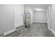 Basement showcasing a water heater, gray walls, and gray vinyl flooring with steps leading to the door at 2030 Houston St, Indianapolis, IN 46218