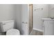 Bathroom showcasing toilet and sink, gray walls, and a towel rack with tiled shower in the background at 2030 Houston St, Indianapolis, IN 46218