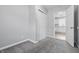Bedroom with a closet, view of the kitchen through the doorway, and neutral walls with carpet flooring at 2030 Houston St, Indianapolis, IN 46218