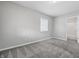 Neutral bedroom with new carpet, a window providing natural light, and an en-suite bathroom at 2030 Houston St, Indianapolis, IN 46218