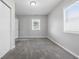 Well-lit bedroom with new gray carpet and two windows providing plenty of natural light at 2030 Houston St, Indianapolis, IN 46218