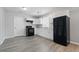 Modern kitchen featuring white cabinets, black appliances, and a stainless steel sink at 2030 Houston St, Indianapolis, IN 46218