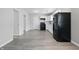 Well-lit kitchen with white cabinets, black appliances, and modern countertops at 2030 Houston St, Indianapolis, IN 46218