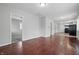 Spacious living area with hardwood floors and an open layout, leading to the kitchen and other rooms at 2030 Houston St, Indianapolis, IN 46218