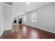 Open-concept living area with hardwood floors flowing into the kitchen featuring black appliances at 2030 Houston St, Indianapolis, IN 46218