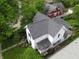 Aerial view of a home showcasing its well-maintained roof, lush landscaping, and neighborhood surroundings at 232 S Audubon Rd, Indianapolis, IN 46219
