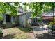 Well-maintained backyard featuring a wooden walkway, patio area with seating, and lush greenery at 232 S Audubon Rd, Indianapolis, IN 46219