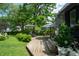 Backyard features a wooden deck with outdoor seating beneath umbrellas and a well-maintained lawn at 232 S Audubon Rd, Indianapolis, IN 46219