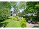 Serene backyard oasis featuring a beautiful fountain, lush greenery, and outdoor seating at 232 S Audubon Rd, Indianapolis, IN 46219