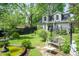 Secluded backyard featuring a decorative fountain, garden bench, and mature landscaping at 232 S Audubon Rd, Indianapolis, IN 46219