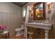 Classic bathroom with a pedestal sink, vintage-style fixtures, and decorative wallpaper at 232 S Audubon Rd, Indianapolis, IN 46219