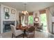 Elegant dining room boasting a fireplace, a chandelier, and neutral-toned walls at 232 S Audubon Rd, Indianapolis, IN 46219
